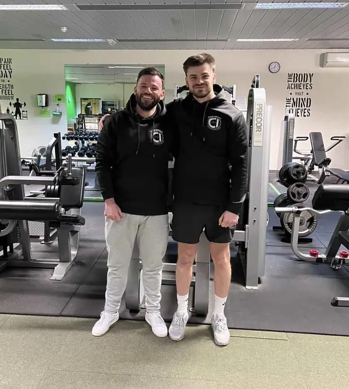 Two gym operators on the floor of their club