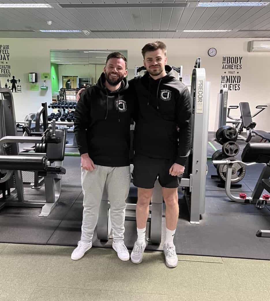 Two gym operators on the floor of their club